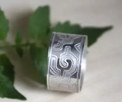Anillo mexicano Ga Yixe con un motivo de grecas mexicanas de formas curvilíneas.