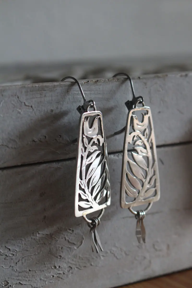 Canción de cuna, aretes ave y helecho en plata