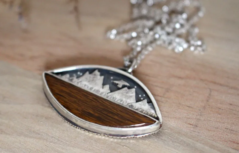 Hacia los cielos, collar águila de la montaña en plata y madera petrificada