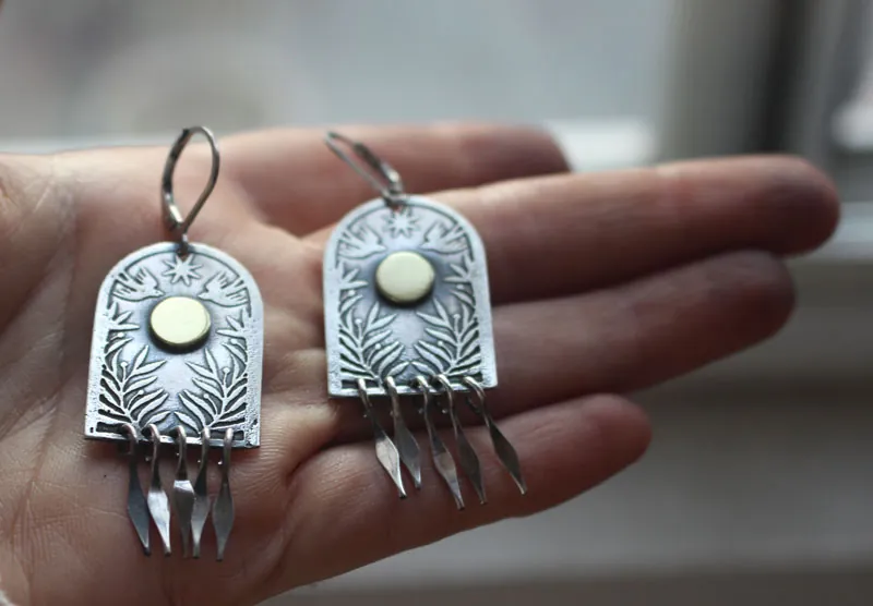 La puerta de las estrellas, aretes de plata y latón