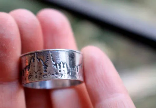 Más allá de las cumbres, anillo montaña y bosque en plata