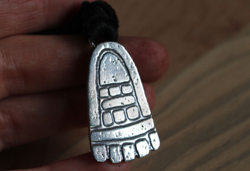 Movement, olmec foot necklace in sterling silver
