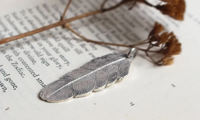 Pluma, dije paz y libertad en plata