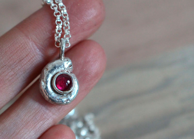 The cradle of life, nautilus ammonite and birthstone necklace in silver and ruby