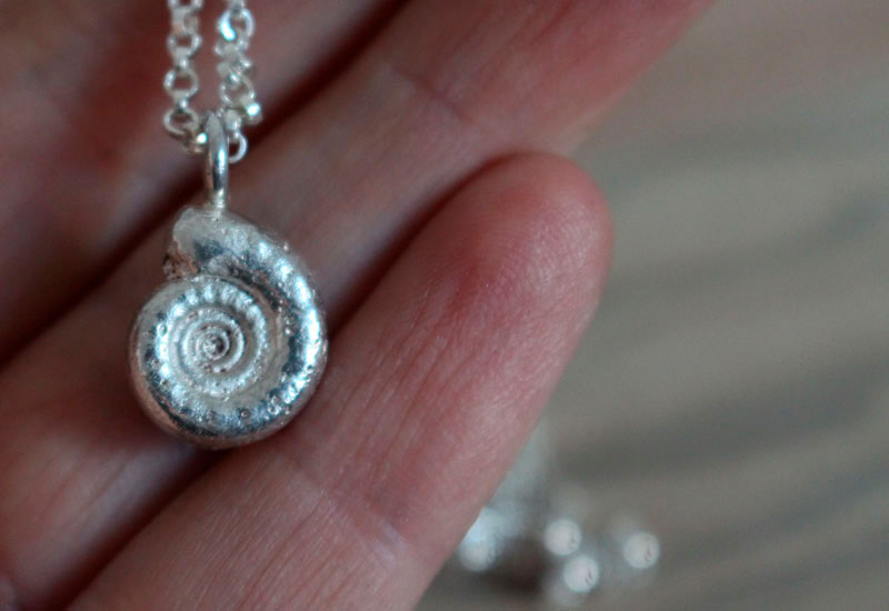 The cradle of life, nautilus ammonite and birthstone necklace in silver and ruby