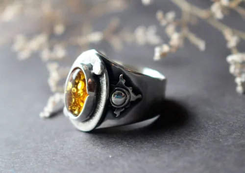 Un halo en la oscuridad, anillo sol en plata y ámbar