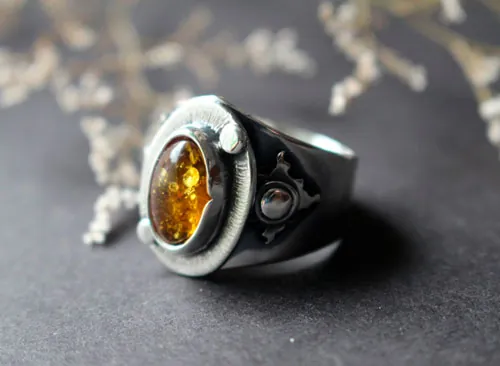 Un halo en la oscuridad, anillo sol en plata y ámbar